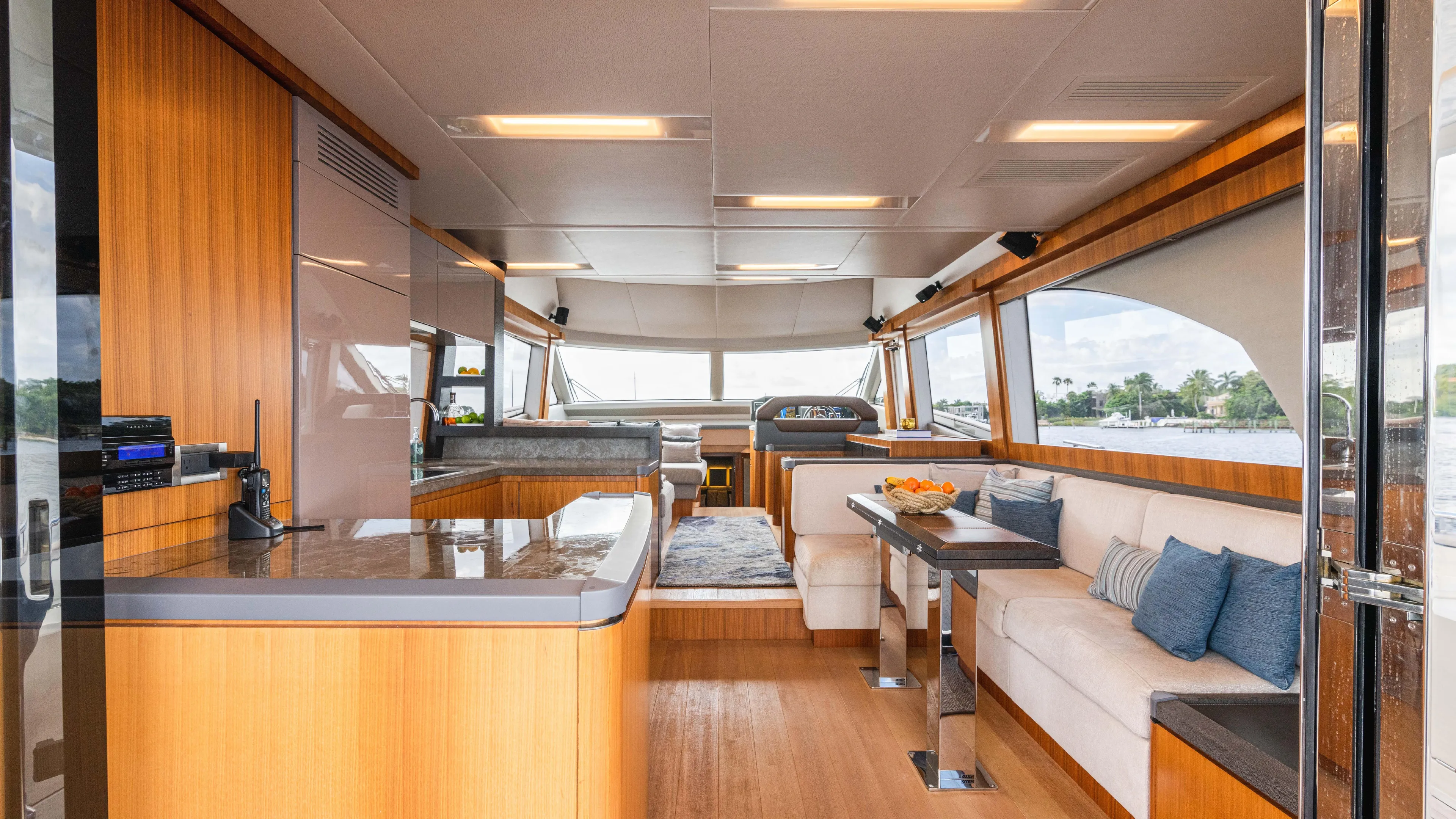 Nauti Style Yacht Photos Pics Luxurious interior of 2016 Monte Carlo Yachts MCY 65 with modern furnishings and panoramic windows.