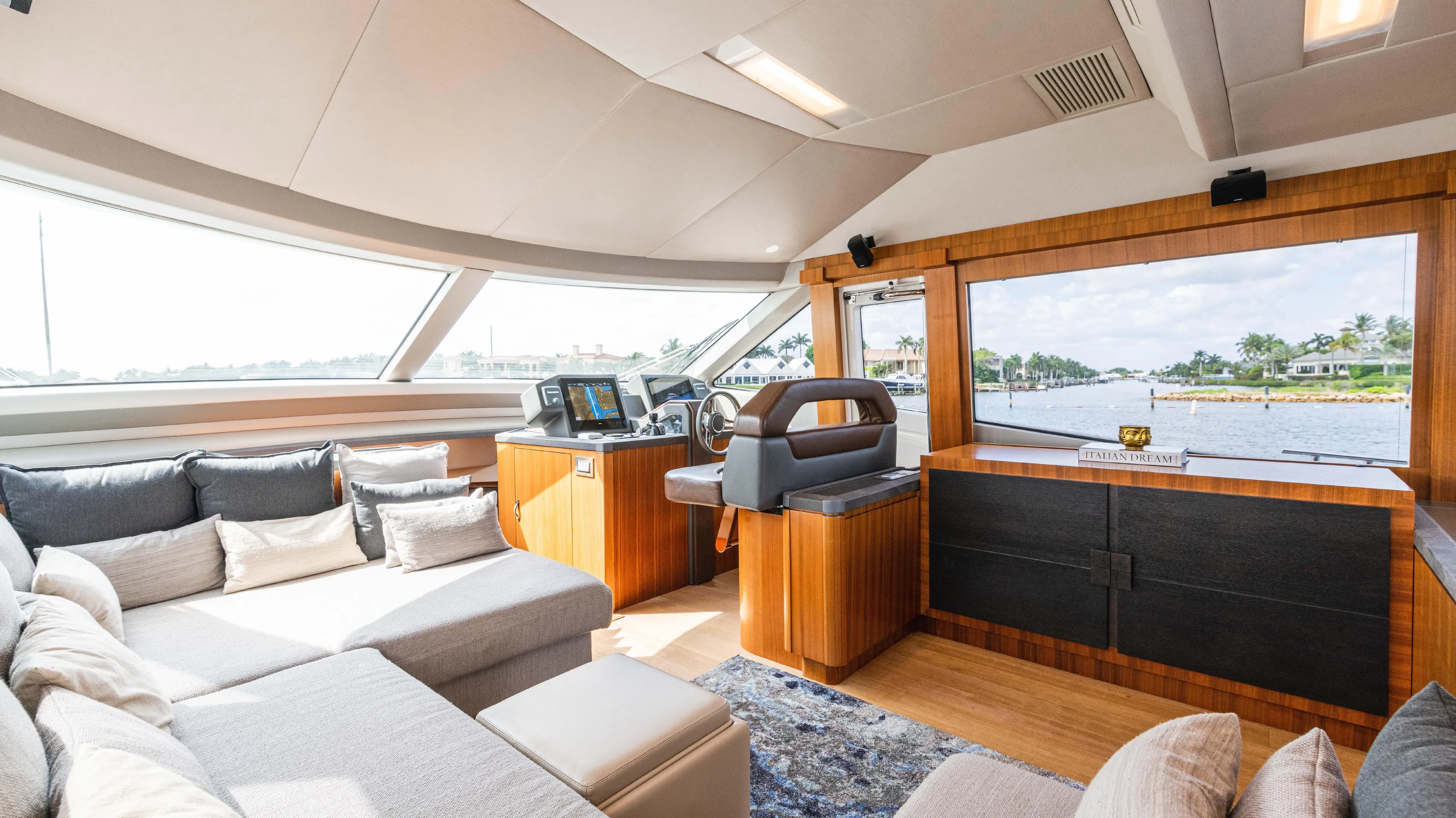 Nauti Style Yacht Photos Pics Luxurious interior of 2016 Monte Carlo Yachts MCY 65 with plush seating and panoramic windows.