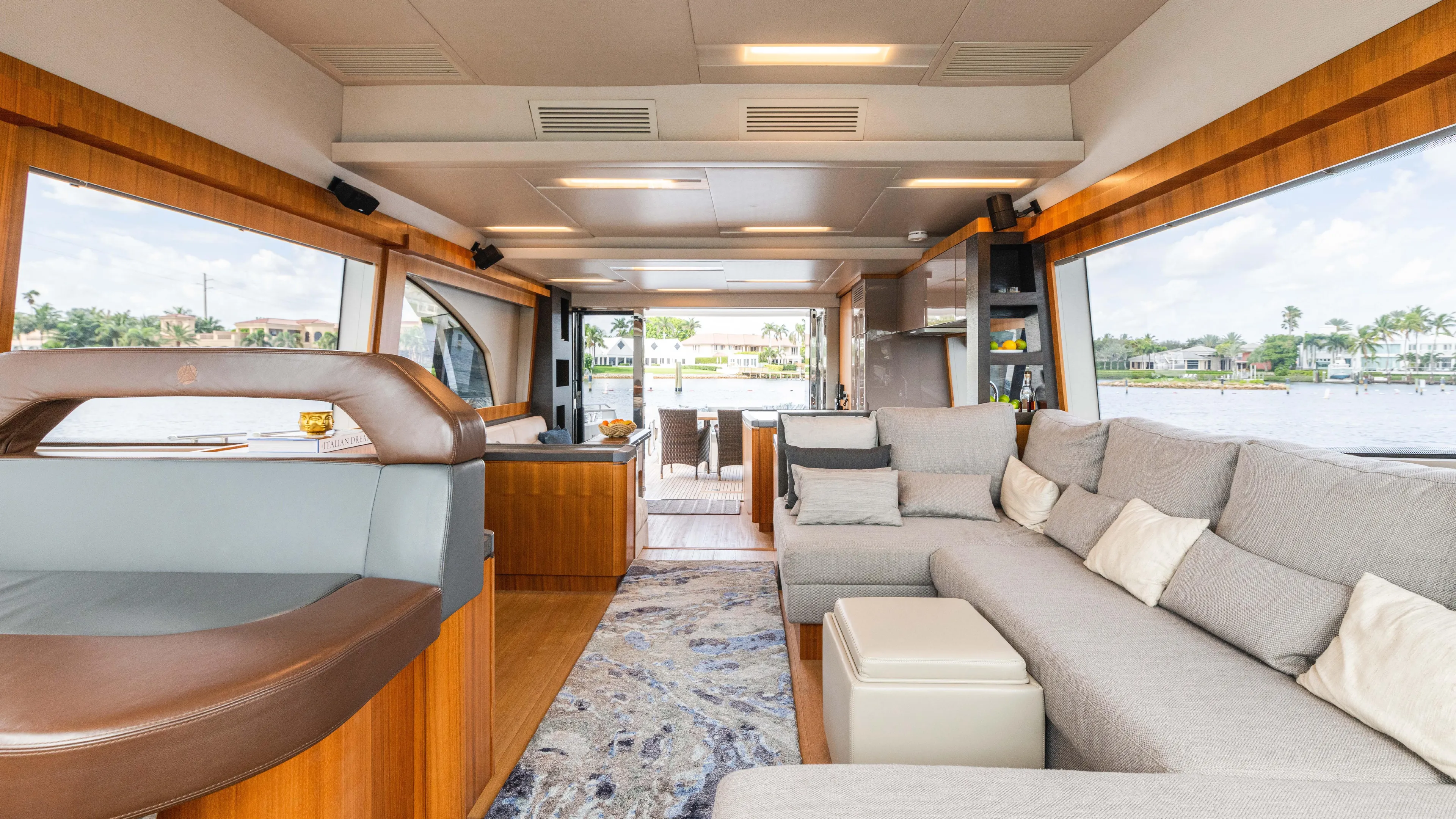 Nauti Style Yacht Photos Pics Luxurious interior of 2016 Monte Carlo Yachts MCY 65 with spacious seating and panoramic windows.