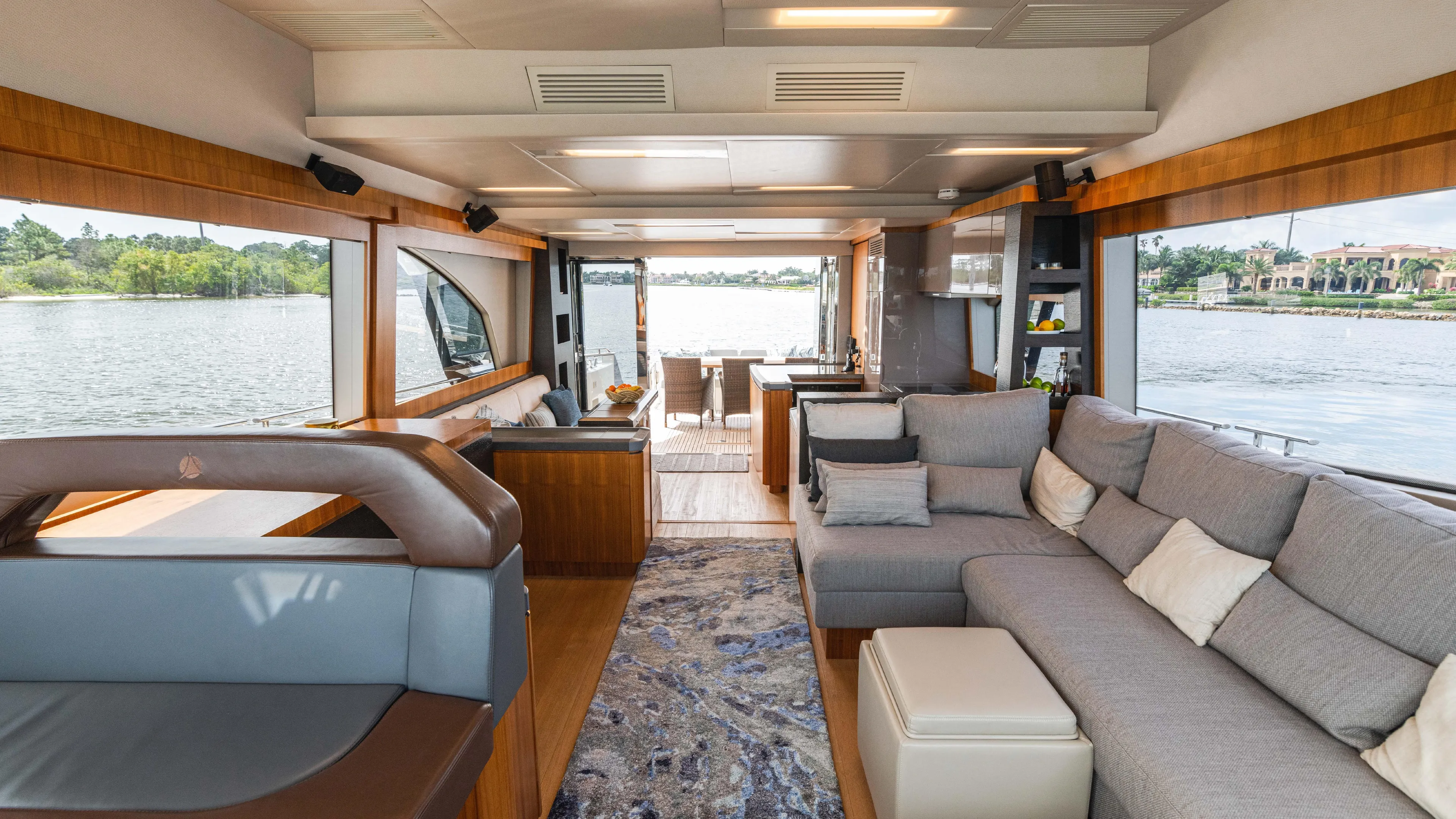 Nauti Style Yacht Photos Pics Luxurious interior of 2016 Monte Carlo Yachts MCY 65 with spacious seating and scenic water views.