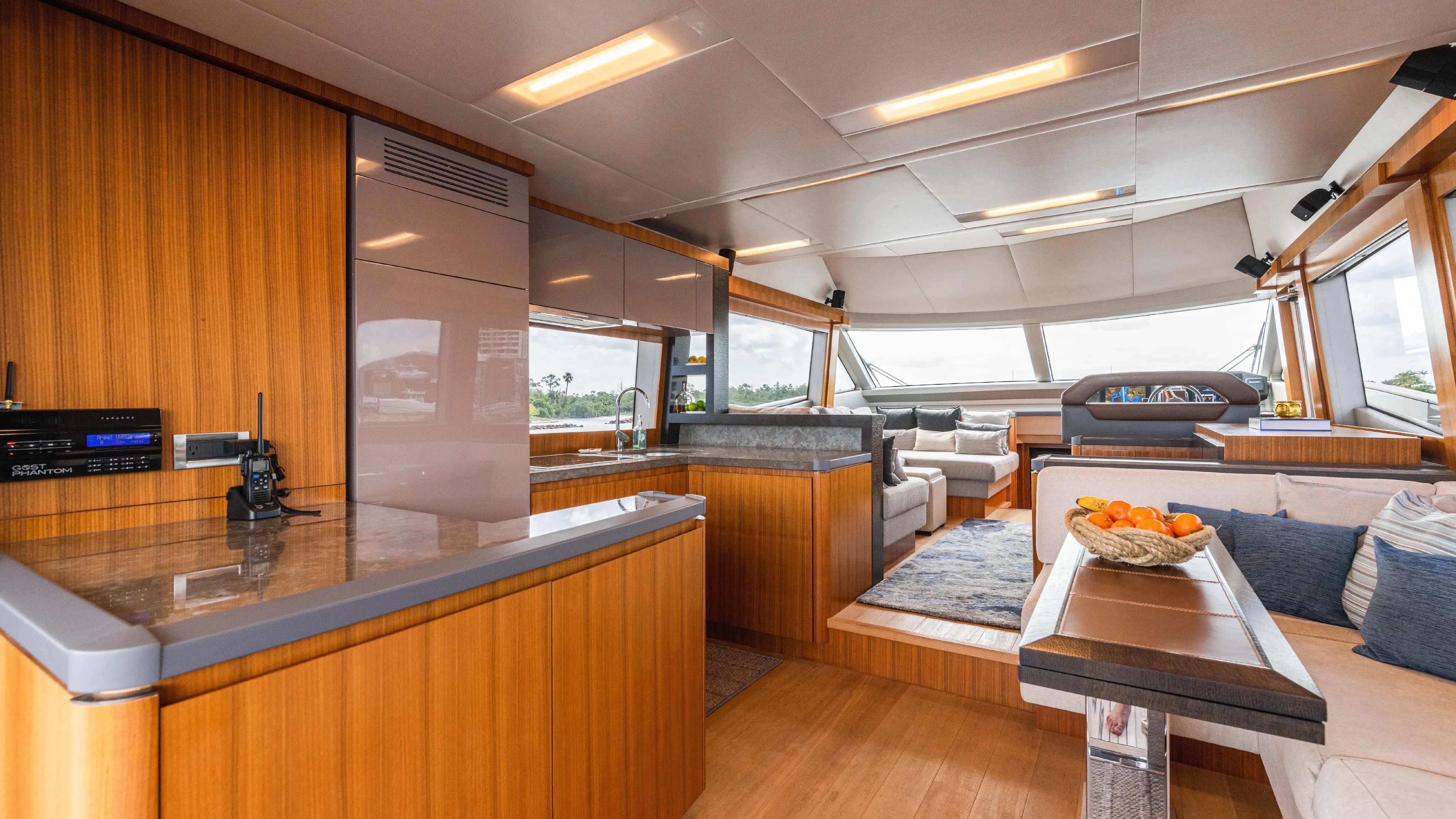 Nauti Style Yacht Photos Pics Luxurious interior of 2016 Monte Carlo Yachts MCY 65 with modern wood finishes and seating area.