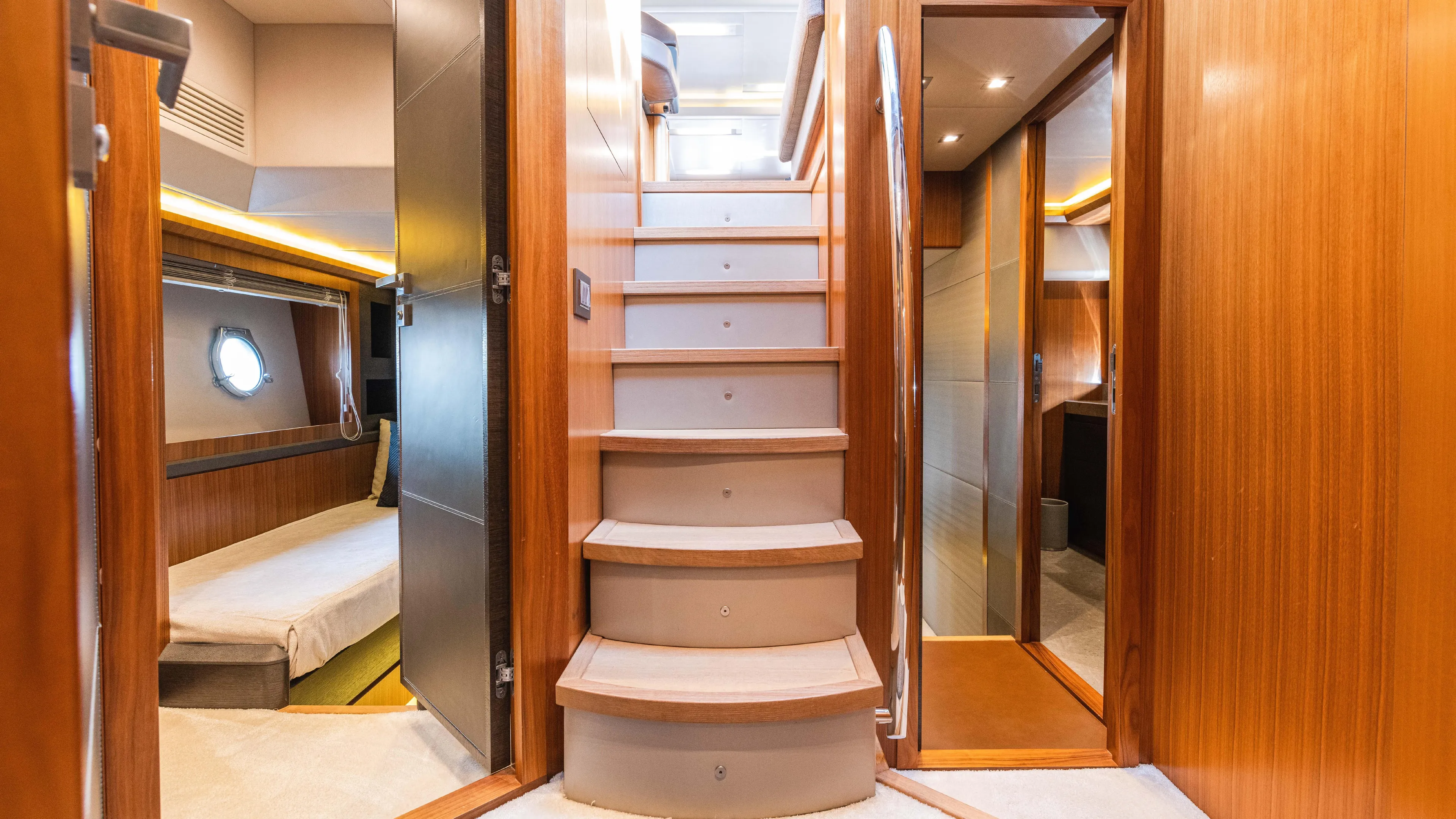 Nauti Style Yacht Photos Pics Luxurious interior of 2016 Monte Carlo Yachts MCY 65 with wooden finishes and elegant staircase.