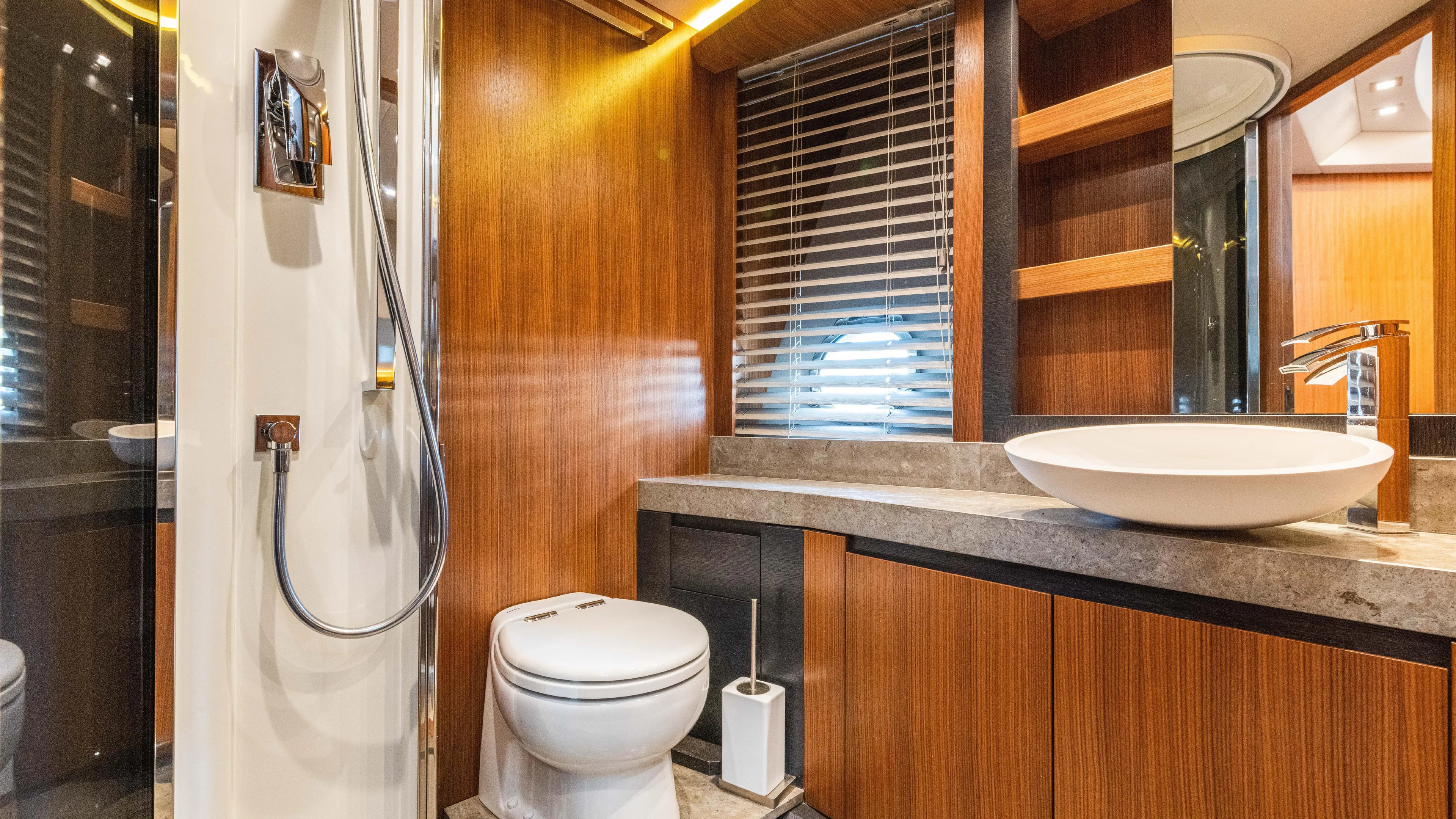 Nauti Style Yacht Photos Pics Luxurious bathroom in 2016 Monte Carlo Yachts MCY 65, featuring modern fixtures and wood accents.