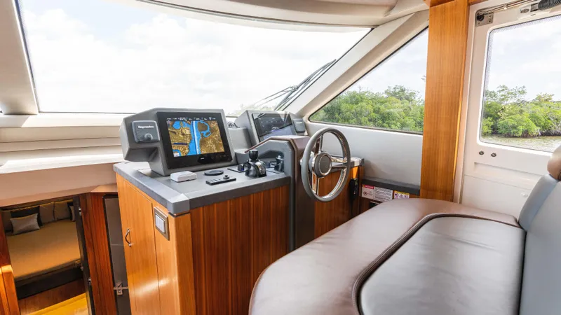 Nauti Style Yacht Photos Pics 2016 Monte Carlo Yachts MCY 65 helm with navigation screens and luxurious interior.