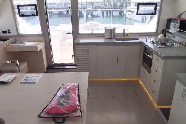 Andiamo Yacht Photos Pics Modern kitchen interior of 2020 Leopard 43 Powercat yacht with appliances and waterfront view.