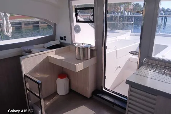 Andiamo Yacht Photos Pics Interior view of 2020 Leopard 43 Powercat yacht with modern kitchen and outdoor access.