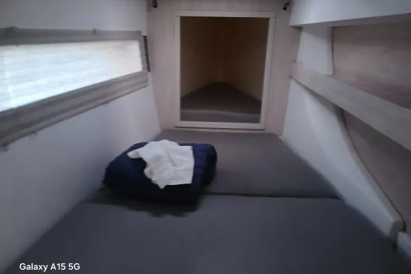 Andiamo Yacht Photos Pics 2020 Leopard 43 Powercat cabin interior with bed and window.