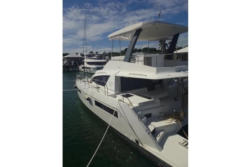 Andiamo Yacht Photos Pics 2020 Leopard 43 Powercat yacht docked at marina under clear blue sky.