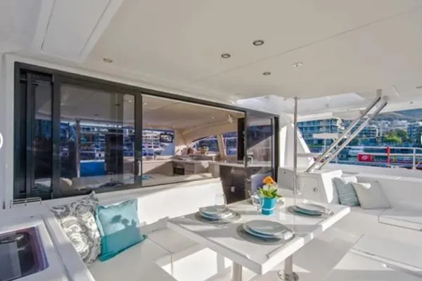 Andiamo Yacht Photos Pics Luxurious 2020 Leopard 43 Powercat yacht interior with elegant dining area and modern decor.