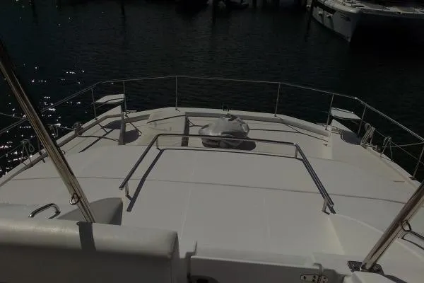 Andiamo Yacht Photos Pics 2020 Leopard 43 Powercat deck view at marina, showcasing spacious layout.
