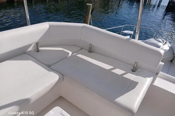 Andiamo Yacht Photos Pics Leopard 43 Powercat 2020 model with white cushioned seating on deck by the water.