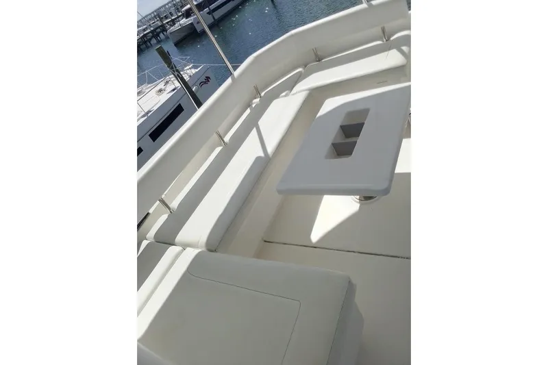 Andiamo Yacht Photos Pics 2020 Leopard 43 Powercat deck with white seating and table, docked at marina.