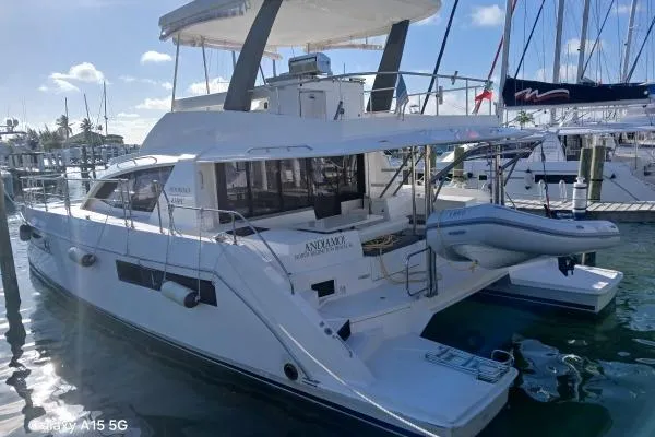 Andiamo Yacht Photos Pics 2020 Leopard 43 Powercat yacht docked at marina with inflatable boat.