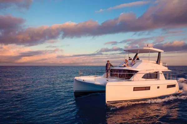 Andiamo Yacht Photos Pics 2020 Leopard 43 Powercat cruising at sunset with passengers on deck.