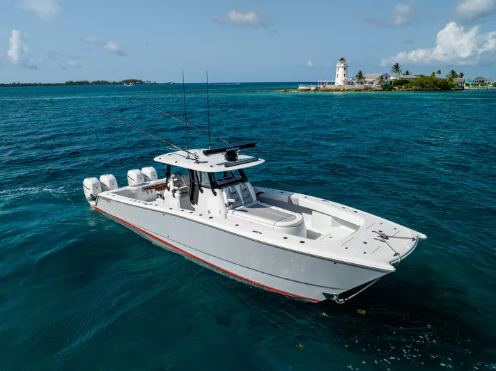  Yacht Photos Pics 2022 Freeman 37 VH boat cruising near a scenic lighthouse and tropical island.