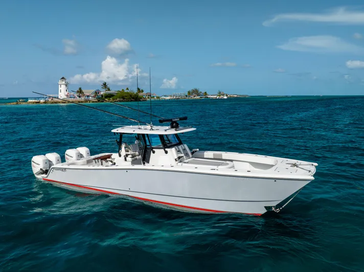  Yacht Photos Pics 2022 Freeman 37 VH boat on blue ocean near island with lighthouse.
