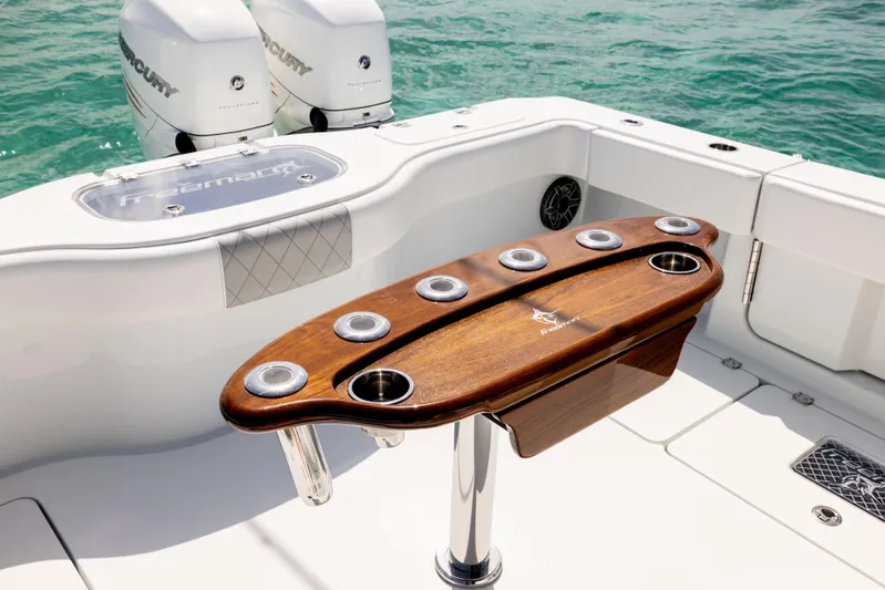  Yacht Photos Pics Freeman 37 VH 2022 boat with wooden rod holder, dual Mercury engines, on clear water.