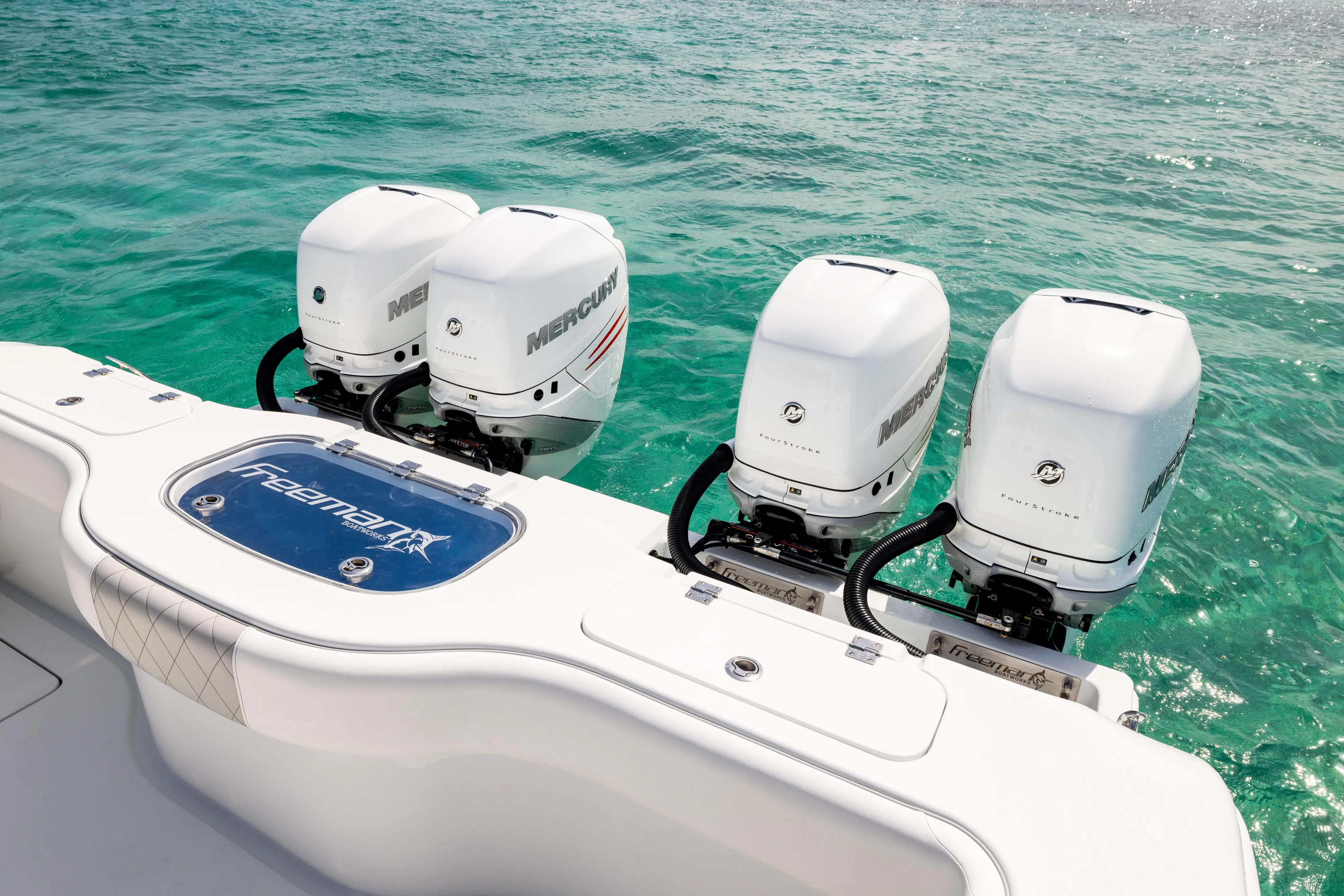  Yacht Photos Pics 2022 Freeman 37 VH boat with four Mercury outboard engines on turquoise water.