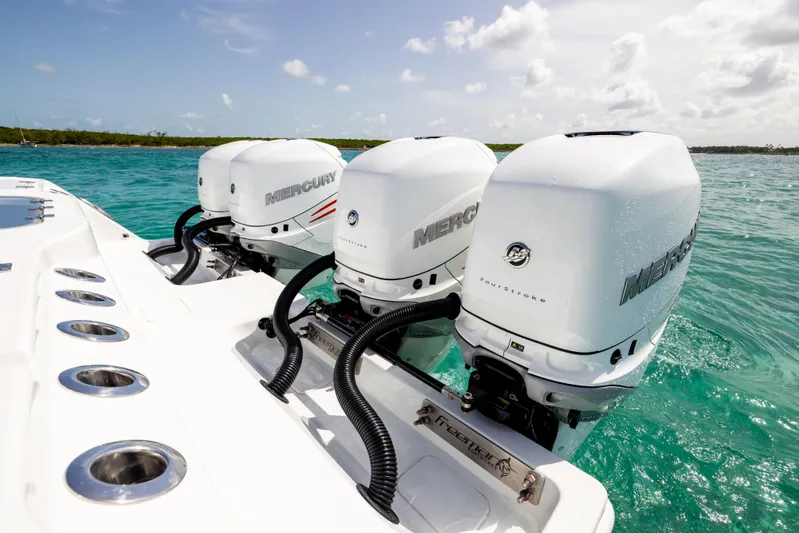  Yacht Photos Pics Triple Mercury outboard engines on a 2022 Freeman 37 VH boat in turquoise waters.
