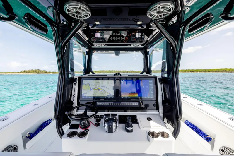  Yacht Photos Pics Freeman 37 VH 2022 boat cockpit with advanced navigation system on clear blue water.