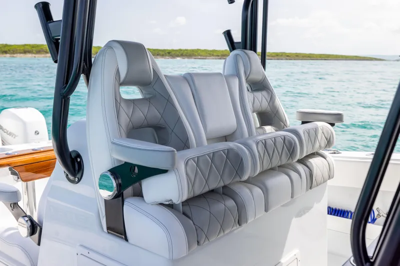  Yacht Photos Pics Luxury seating on a 2022 Freeman 37 VH boat, featuring quilted upholstery and ocean backdrop.