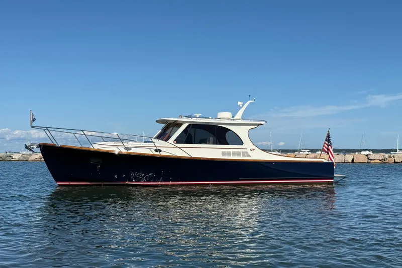 Sterling Yacht Photos Pics 2024 Hinckley Picnic Boat 40 S on calm water, showcasing elegant design and craftsmanship.