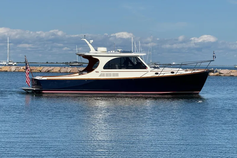Sterling Yacht Photos Pics 2024 Hinckley Picnic Boat 40 S cruising on calm waters under a clear sky.
