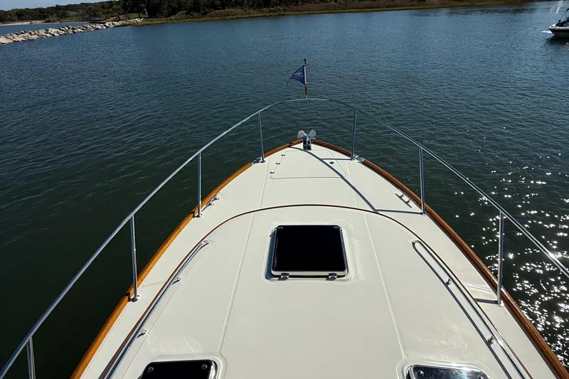 Sterling Yacht Photos Pics 2024 Hinckley Picnic Boat 40 S cruising on calm waters, showcasing its elegant deck design.