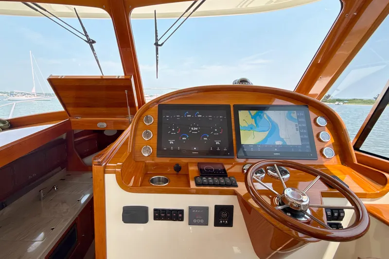 Sterling Yacht Photos Pics 2024 Hinckley Picnic Boat 40 S helm with navigation screens and wooden steering wheel.