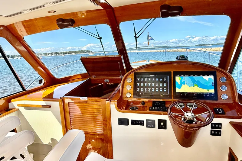 Sterling Yacht Photos Pics 2024 Hinckley Picnic Boat 40 S helm with modern navigation displays and wooden accents.