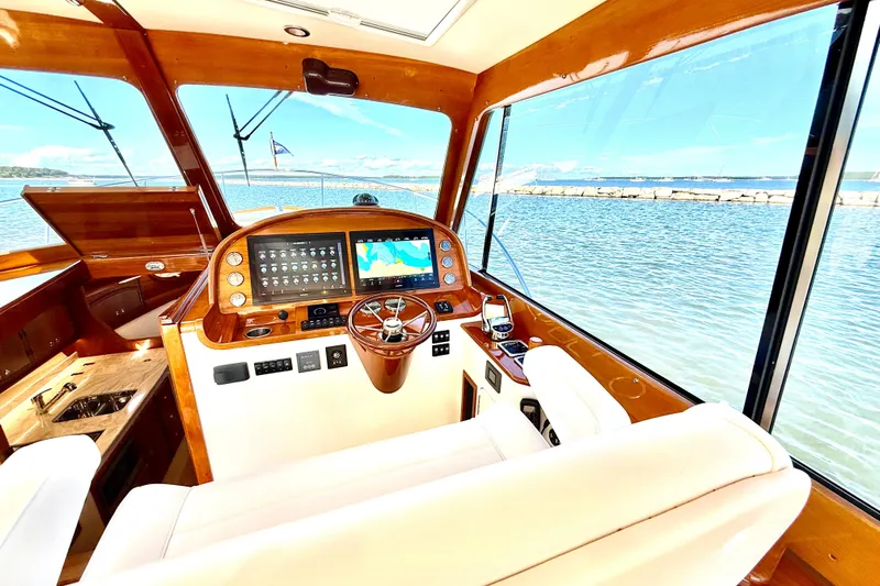 Sterling Yacht Photos Pics 2024 Hinckley Picnic Boat 40 S helm with luxurious wood finish and modern navigation system.