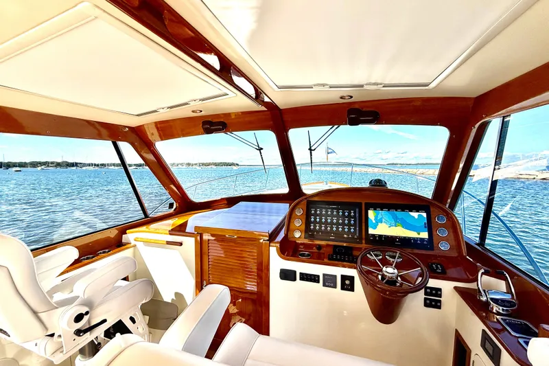 Sterling Yacht Photos Pics 2024 Hinckley Picnic Boat 40 S interior with navigation system, overlooking serene waters.