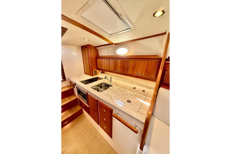 Sterling Yacht Photos Pics Luxurious galley in 2024 Hinckley Picnic Boat 40 S with wood cabinetry and modern appliances.