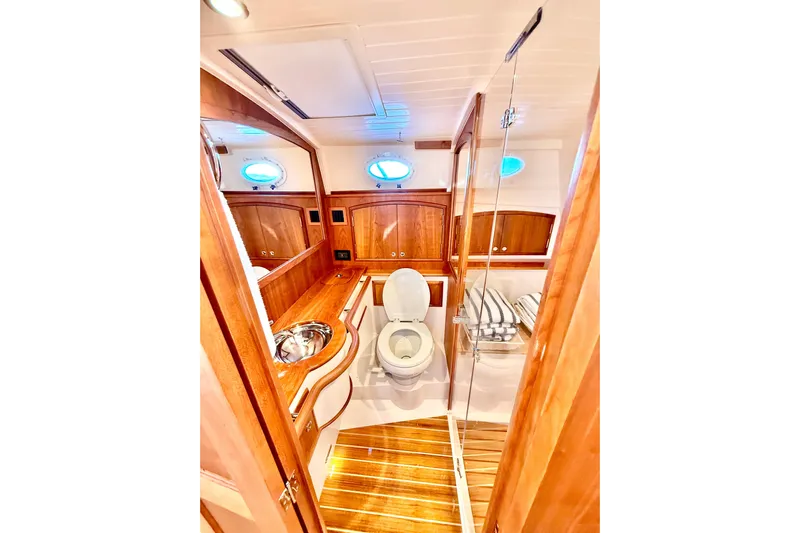 Sterling Yacht Photos Pics Luxurious 2024 Hinckley Picnic Boat 40 S bathroom with elegant wood finish and modern fixtures.