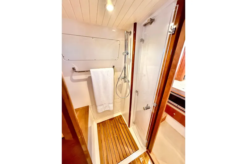 Sterling Yacht Photos Pics 2024 Hinckley Picnic Boat 40 S bathroom with wooden flooring and modern shower.