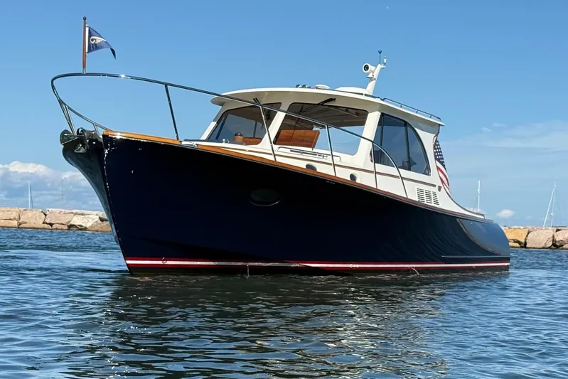 Sterling Yacht Photos Pics 2024 Hinckley Picnic Boat 40 S on calm water, showcasing elegant design and craftsmanship.