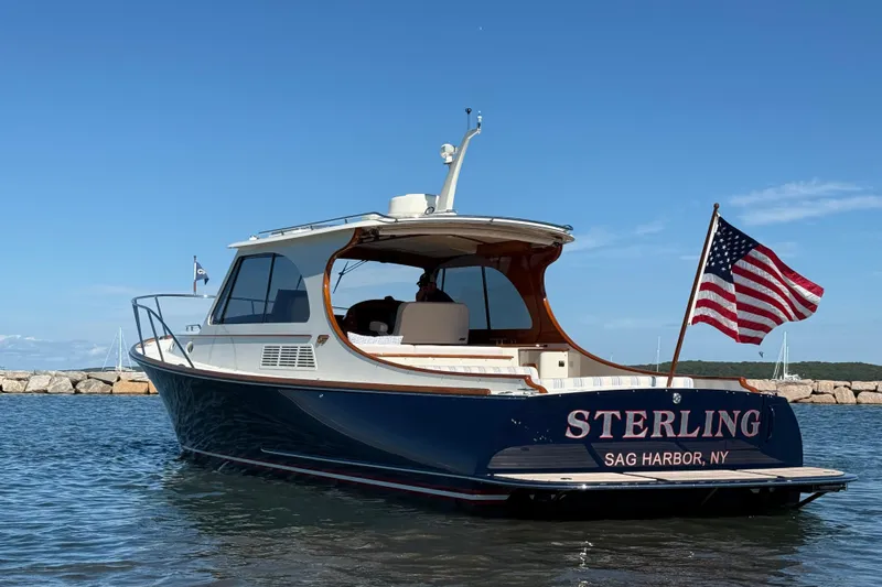 Sterling Yacht Photos Pics 2024 Hinckley Picnic Boat 40 S in water, American flag, Sag Harbor, NY.