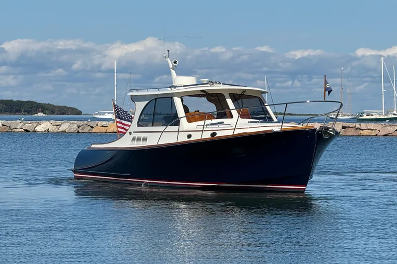 Sterling Yacht Photos Pics 2024 Hinckley Picnic Boat 40 S cruising in a serene harbor setting.