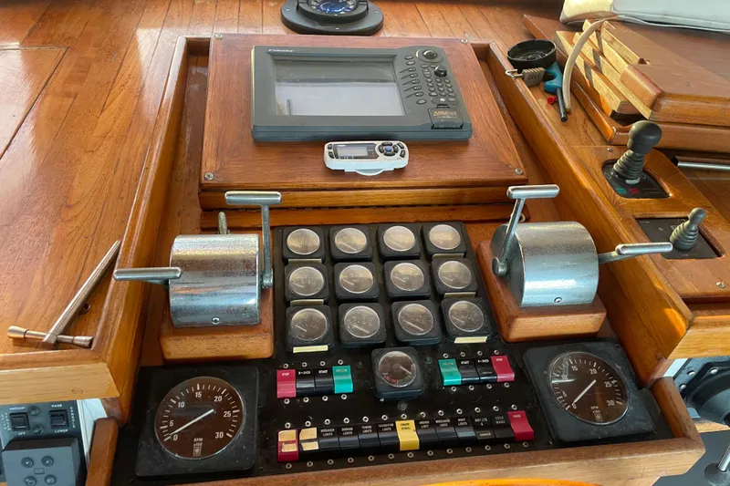  Yacht Photos Pics Control panel of a 1969 Islander 72 Aft Cabin Motor Yacht with gauges and levers.