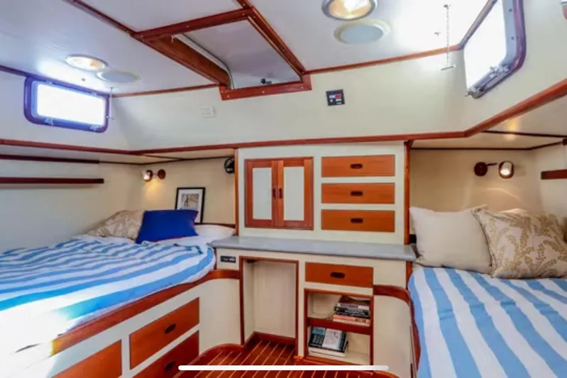  Yacht Photos Pics 1969 Islander 72 Aft Cabin Motor Yacht interior with twin beds and wooden cabinetry.