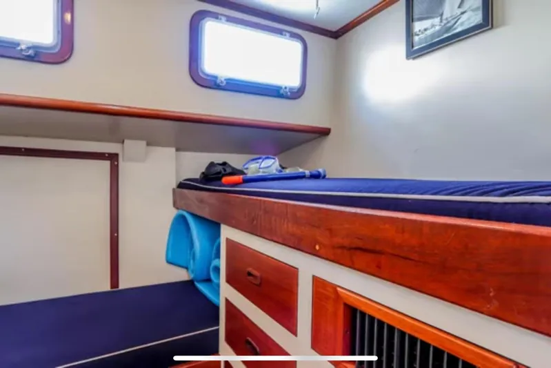  Yacht Photos Pics Interior cabin of 1969 Islander 72 Aft Cabin Motor Yacht with wooden accents and storage.