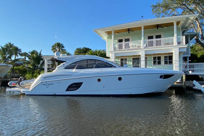 “amor Fati” Yacht Photos Pics 2014 Beneteau Gran Turismo 44 yacht docked by a waterfront house.