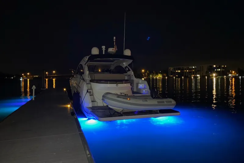 “amor Fati” Yacht Photos Pics 2014 Beneteau Gran Turismo 44 yacht docked at night with blue underwater lights.