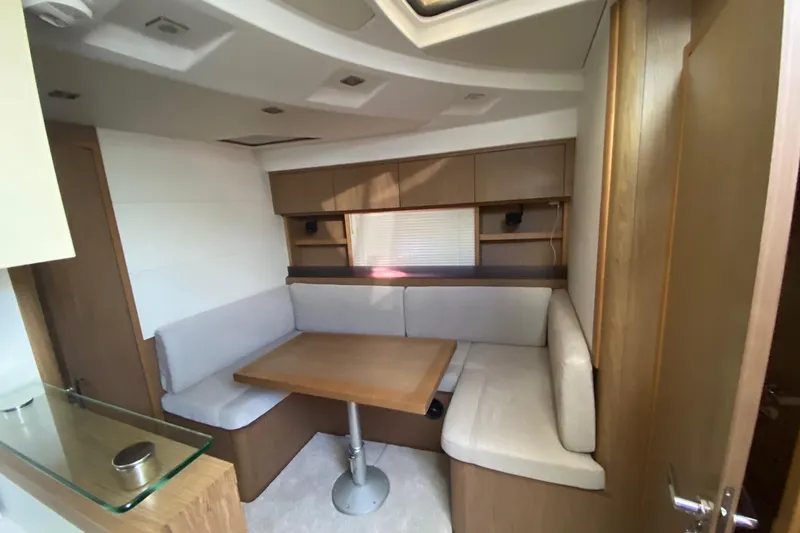 “amor Fati” Yacht Photos Pics 2014 Beneteau Gran Turismo 44 interior with cozy dining area and wooden cabinetry.