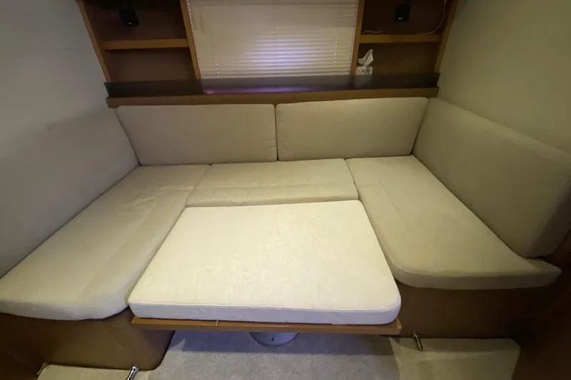 “amor Fati” Yacht Photos Pics Interior seating area of 2014 Beneteau Gran Turismo 44 yacht with beige cushions.