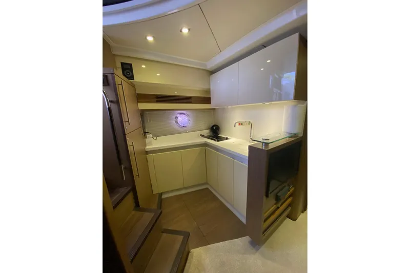 “amor Fati” Yacht Photos Pics Modern kitchen interior of 2014 Beneteau Gran Turismo 44 yacht, featuring sleek cabinetry and lighting.