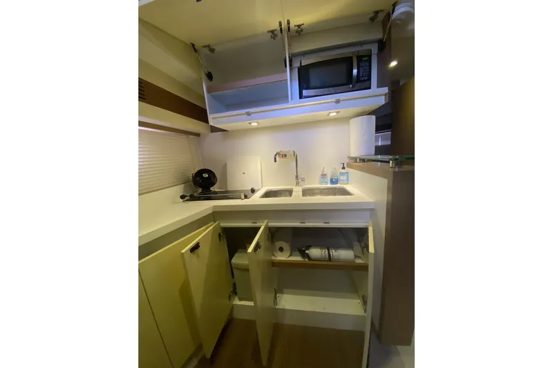 “amor Fati” Yacht Photos Pics Compact kitchen in 2014 Beneteau Gran Turismo 44 yacht with microwave, sink, and storage.