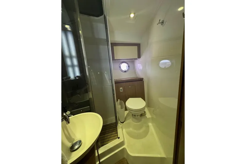 “amor Fati” Yacht Photos Pics Bathroom interior of 2014 Beneteau Gran Turismo 44 yacht, featuring modern fixtures and porthole window.