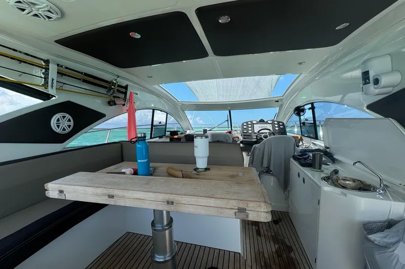 “amor Fati” Yacht Photos Pics Interior of 2014 Beneteau Gran Turismo 44 yacht with wooden table and modern amenities.