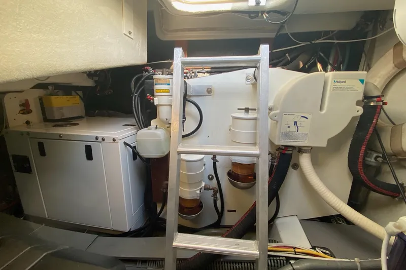 “amor Fati” Yacht Photos Pics Engine room of a 2014 Beneteau Gran Turismo 44 with visible machinery and ladder.